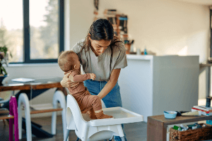 woman placing a child in a car seat