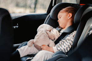 child sleeping in a car seat