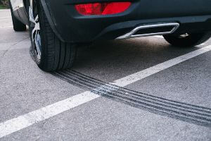 black sports car making skid marks