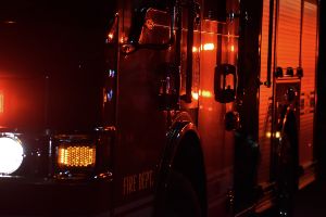 red fire truck with lights on at night