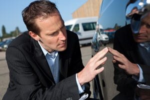 car insurer inspecting vehicle