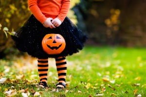 child holding a pumpkin