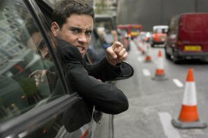an angry driver hanging out of car window