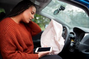 driver behind a deflated airbag