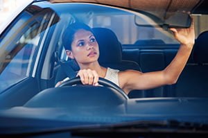 driver looking in rear view mirror