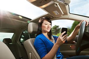 woman on phone while driving