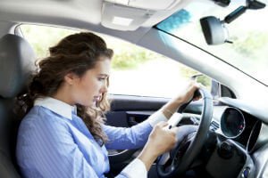 female driver texting