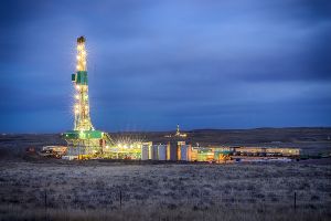 lit up fracking rig at night