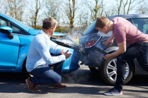 inspecting damage after a car crash
