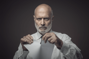 man ripping paper