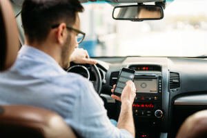 man texting and driving