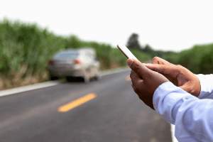 person texting by the side of the road