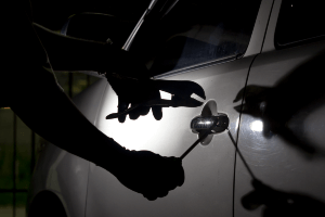 person trying to break into a vehicle