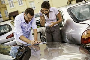 signing paper on a car trunk