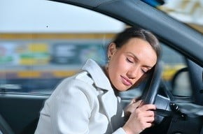 woman asleep on steering wheel