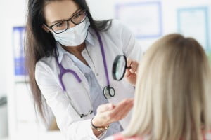 surgeon looking at a face
