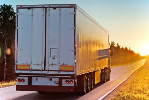 truck driving into sunset