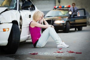 woman next to crashed car