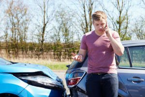 young driver on phone after a crash