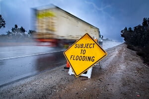 Big rig truck speeding on highway in heavy rain