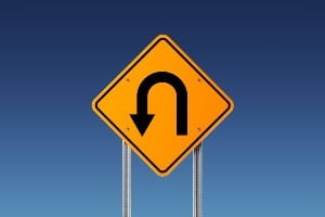 photo illustration of a U-turn sign