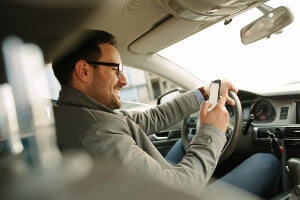 stock image of a man texting and driving