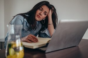 photo illustration of young woman feeling bad at work