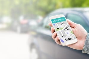 hand holding a smartphone with an open rideshare app