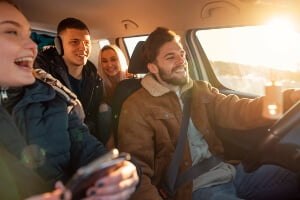 four teens riding in a car