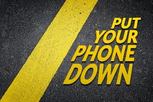 photo illustration telling drivers to put their phone down