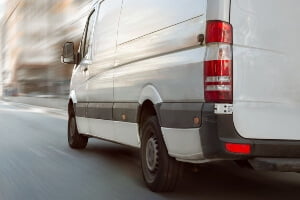 img of a white moving van from behind the vehicle