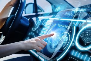 close-up of a driver's hands pointing at automotive software screen on the dashboard