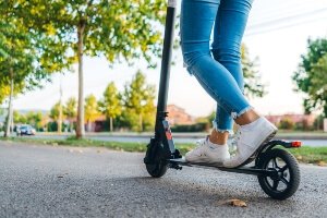 stock image of young woman riding e-scooter