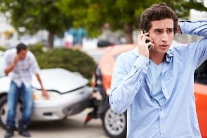 young man calling for help after car crash