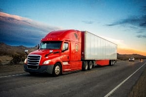 18-Wheeler truck driving down the street.