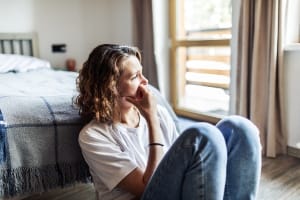 A woman on the floor with depression.