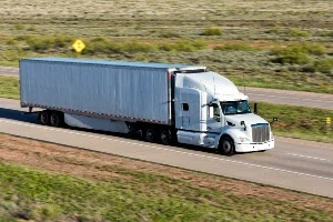 A semi-truck driving on a highway in Texas.