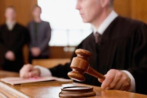 A judge preparing to use the gavel.