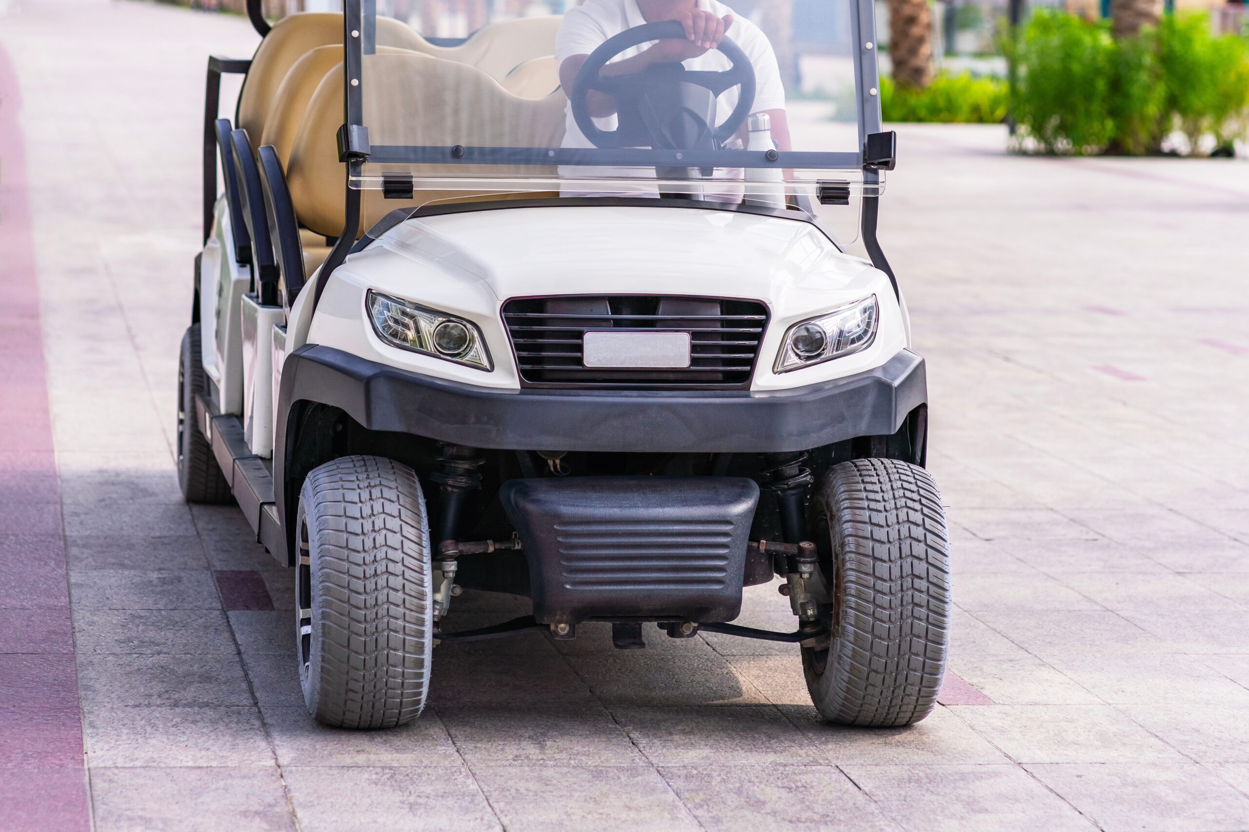 Golf cart driving down the street
