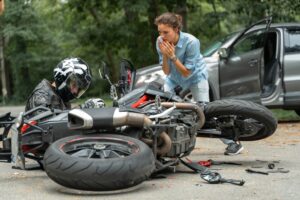 woman ran over motorcycle in road with her car